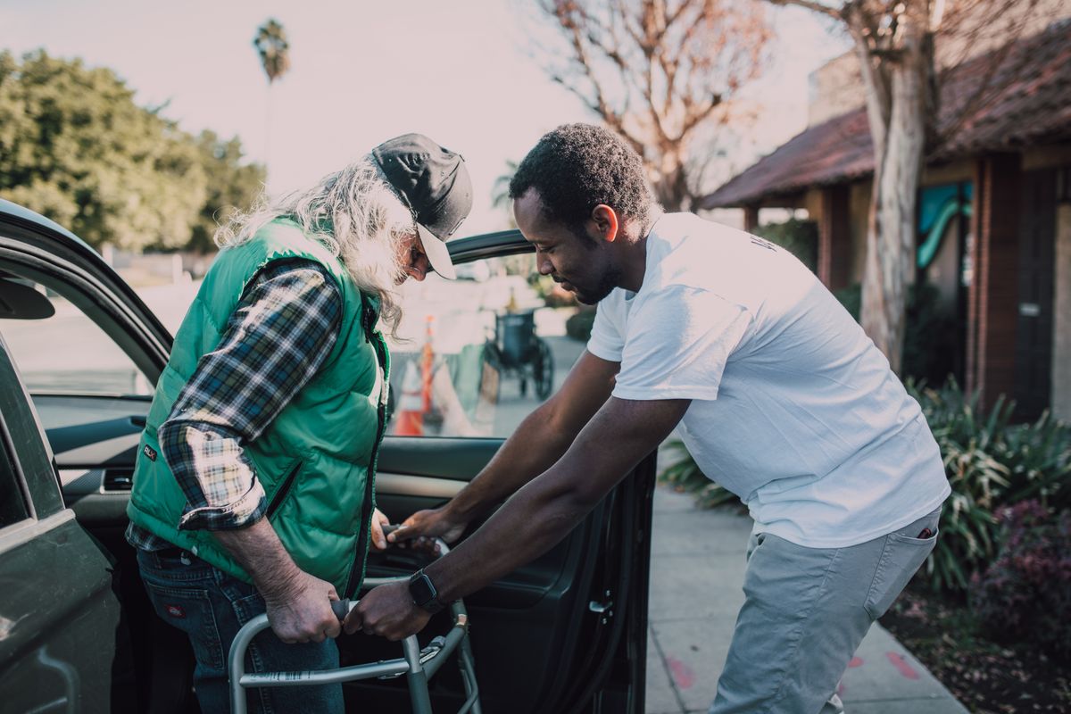 A support worker assisting an individual with hands-on, person-centered care